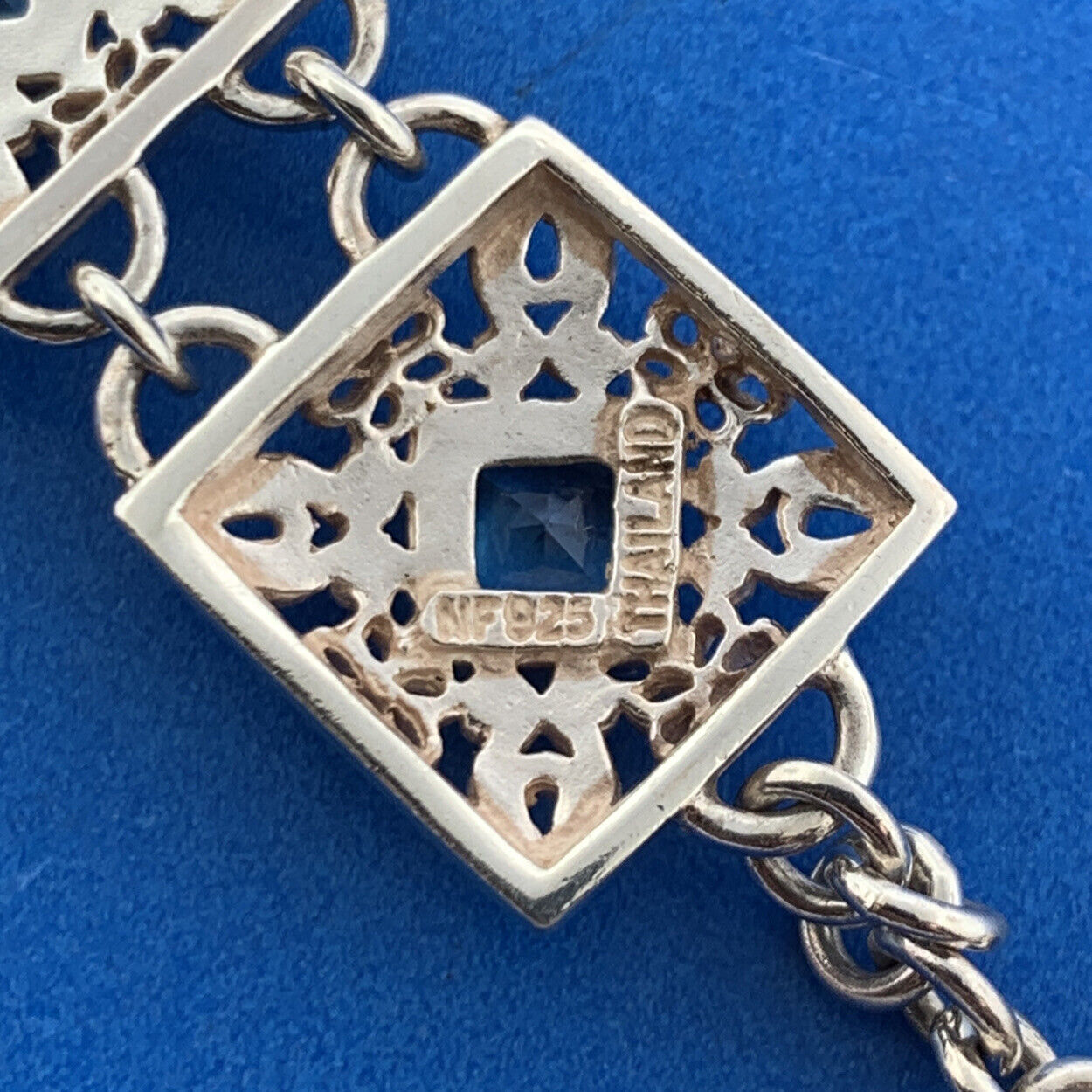 Designer NF Sterling Silver Square Blue Topaz Open Scroll Toggle Tennis Bracelet