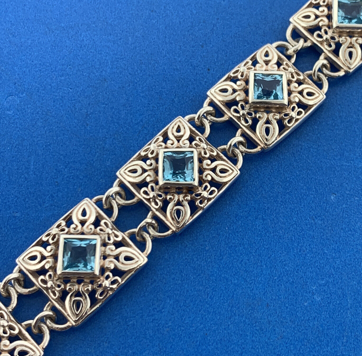 Designer NF Sterling Silver Square Blue Topaz Open Scroll Toggle Tennis Bracelet