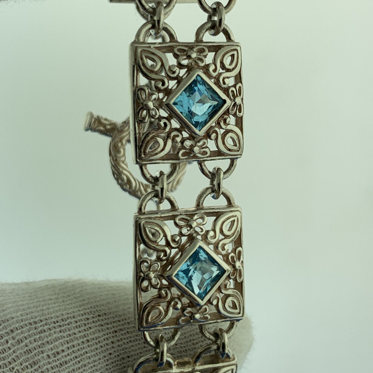 Designer NF Sterling Silver Square Blue Topaz Open Scroll Toggle Tennis Bracelet