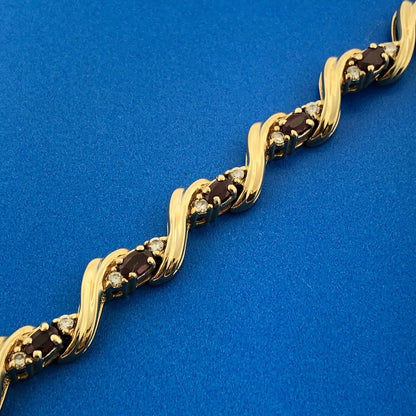 Gorgeous 14k Yellow Gold Oval Cut Ruby Diamond Accent Swirling Tennis Bracelet