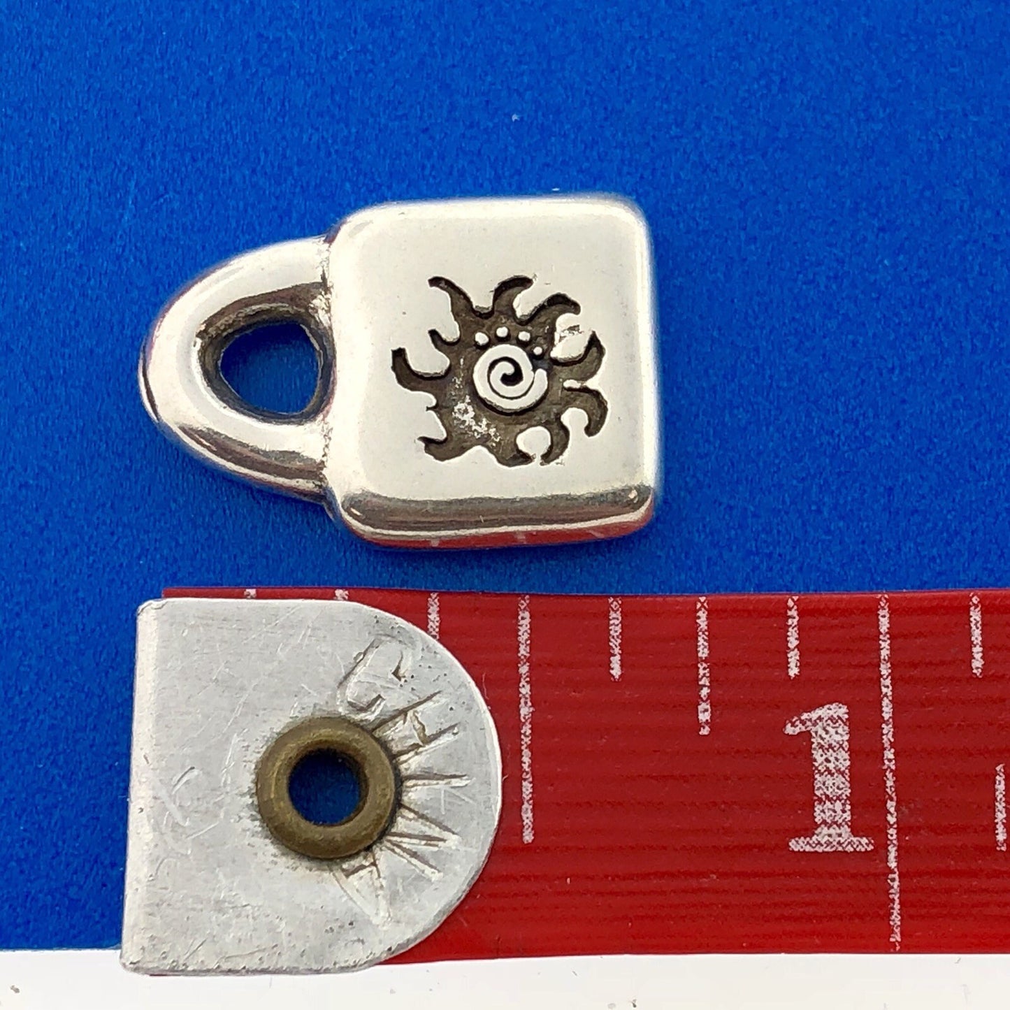 Designer Uno De 50 Silver Tone Sun Burst Purse Lock Charm Pendant