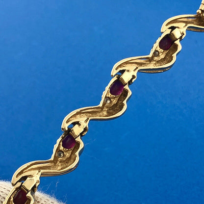 Gorgeous 14k Yellow Gold Oval Cut Ruby Diamond Accent Swirling Tennis Bracelet