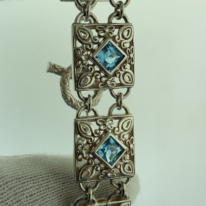 Designer NF Sterling Silver Square Blue Topaz Open Scroll Toggle Tennis Bracelet