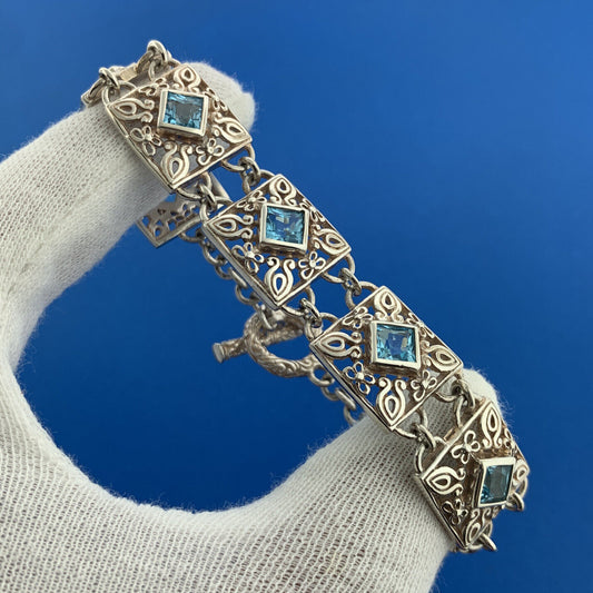 Designer NF Sterling Silver Square Blue Topaz Open Scroll Toggle Tennis Bracelet